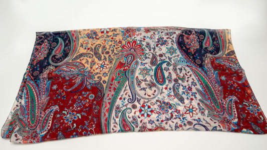 cotton voile shawl featuring intricate designs with red, orange, white, and blue tones.