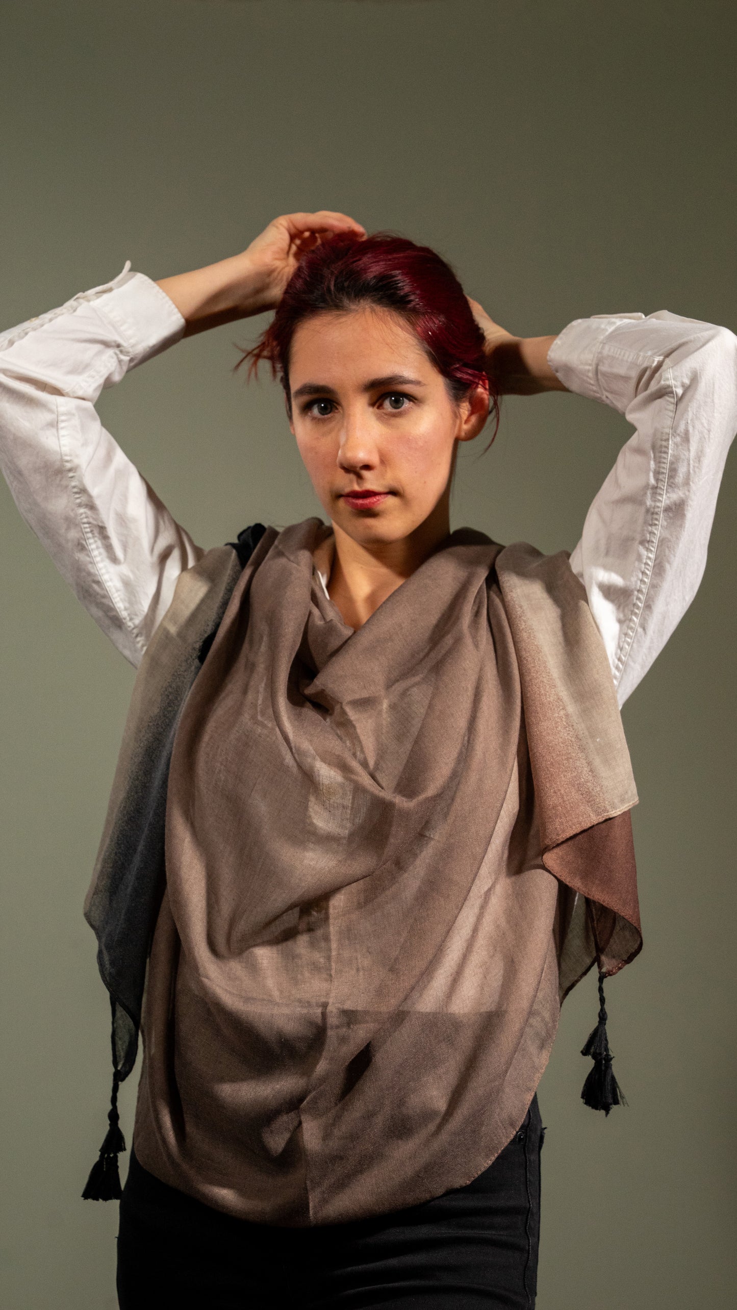 female model wearing wool silk shawl with earthly tones of light and dark brown and black on her body