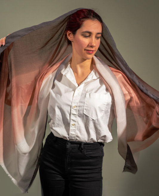 model holding up multi-colored wool silk shawl with grey, beige, light pink, light breown, dark brown