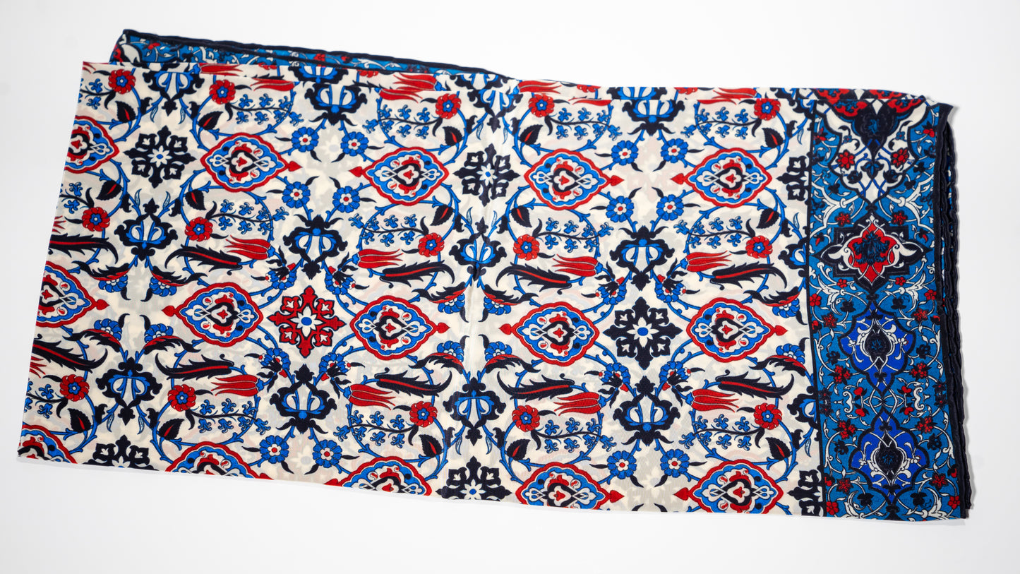 vegan silk scarf with blue, red, black and white tones, featuring intricate patterns. Folded