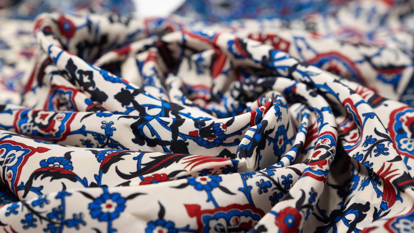 vegan silk scarf with blue, red, black and white tones, featuring intricate patterns. close-up