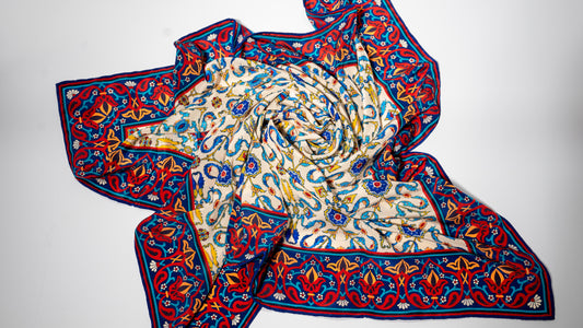 vegan silk scarf with yellow, red, beige, and blue tones, featuring intricate designs.