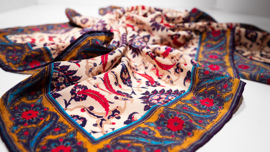 vegan silk scarf with yellow, red, beige, and purple tones. close-up