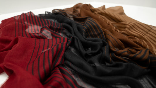 wool silk shawl of red, black, and brown. close up shot