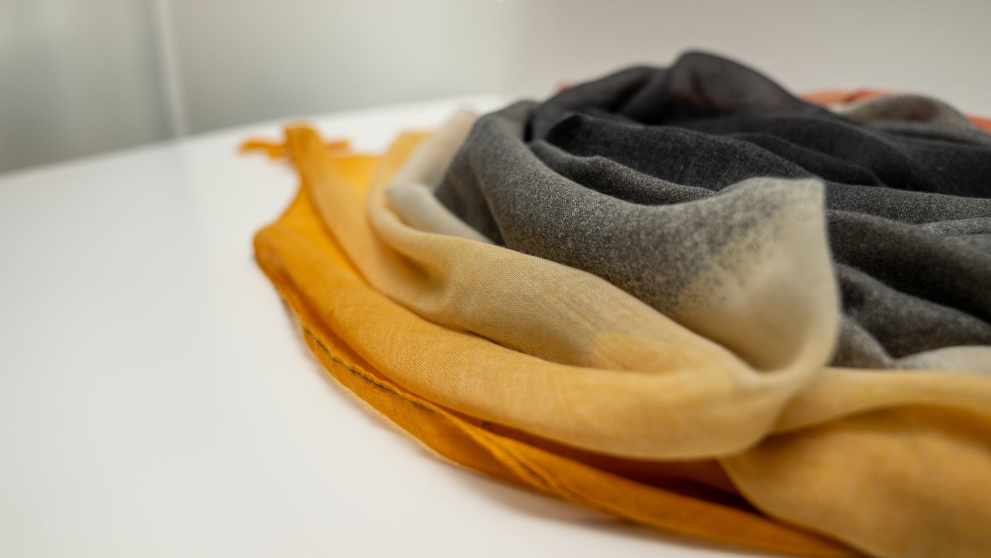 wool silk shawl with light pink/orange, yellow, white, and black. detailed close-up of texture