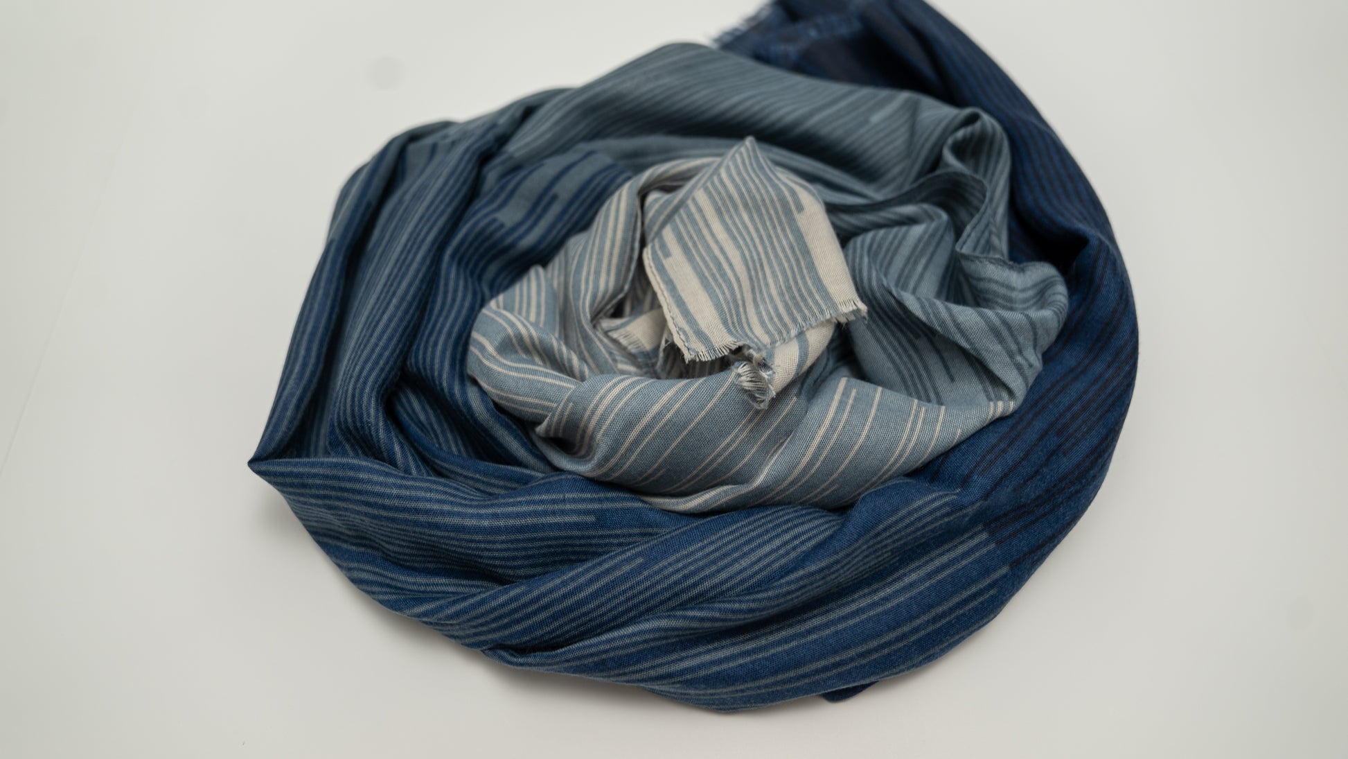 wool silk shawl with dark and light blue and lighter beige tones. wrapped