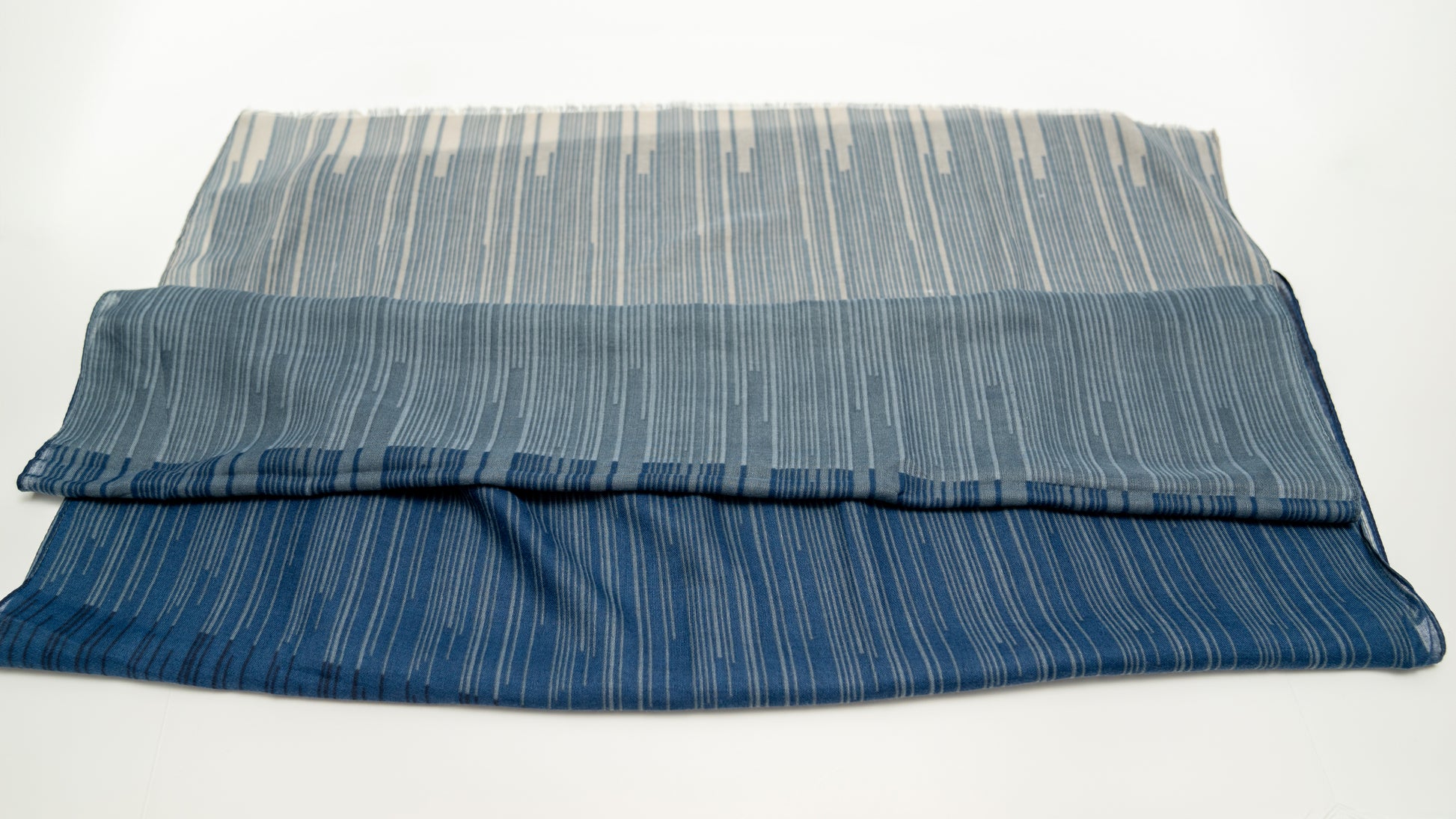 wool silk shawl with dark and light blue and lighter tones. folded front