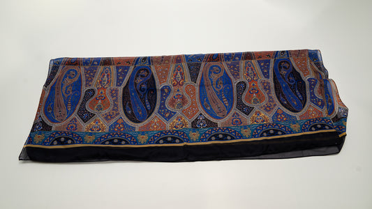 colourful cotton voile shawl with intricate designs, featuring black, blue, and orange tones. Folded