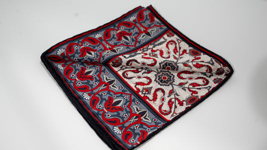 vegan silk scarf with white, grey, and  red tones with floral designs. folded