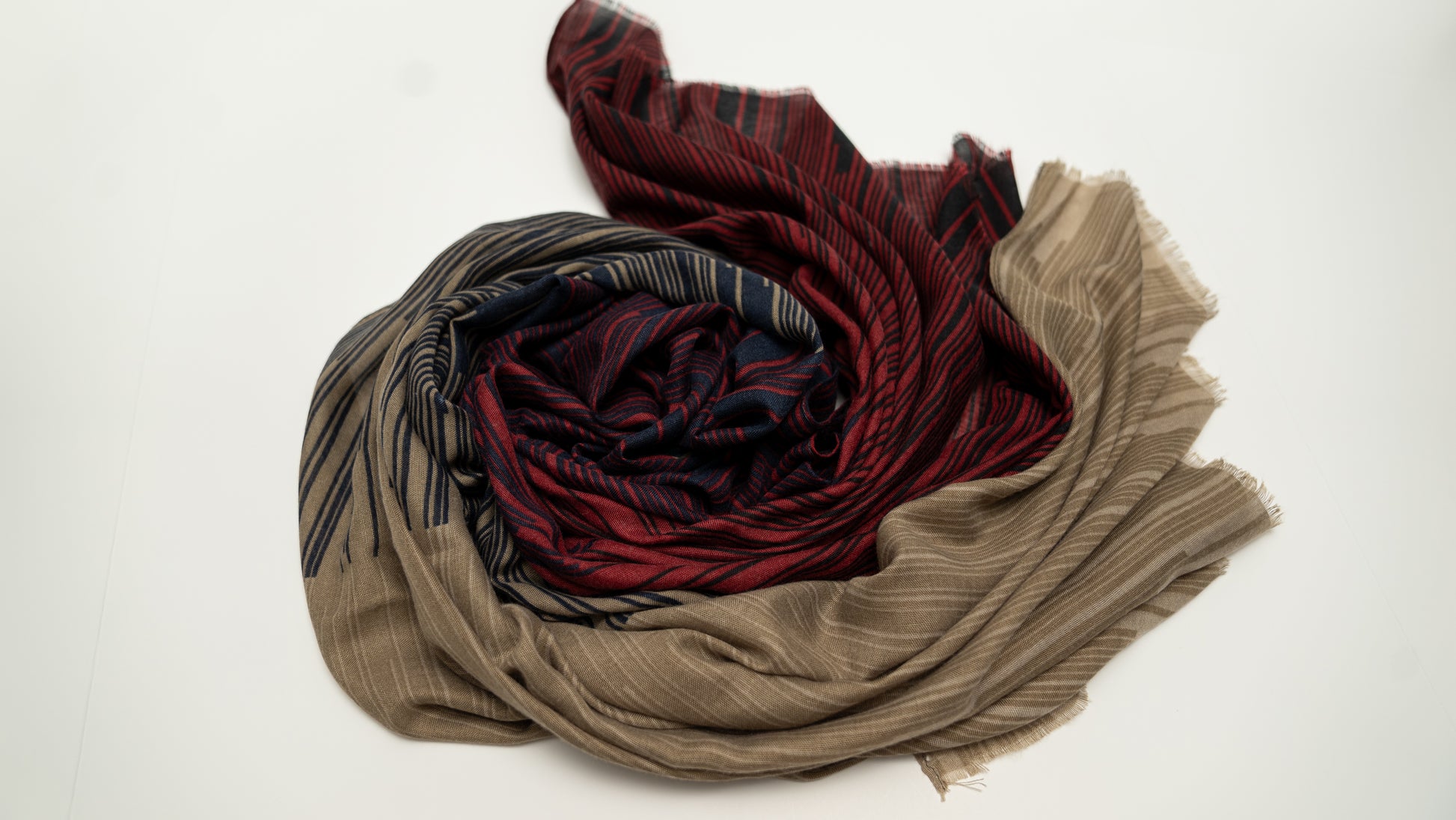 Wool silk scarf with light brown, dark navy black, and red. wrapped.