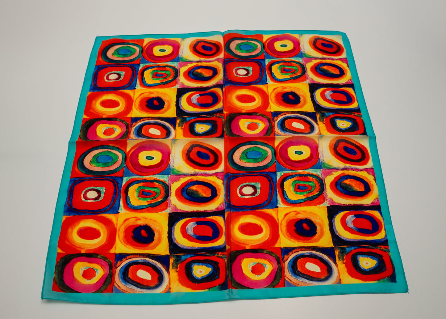 a warmly colorful square vegan silk bandana with circles