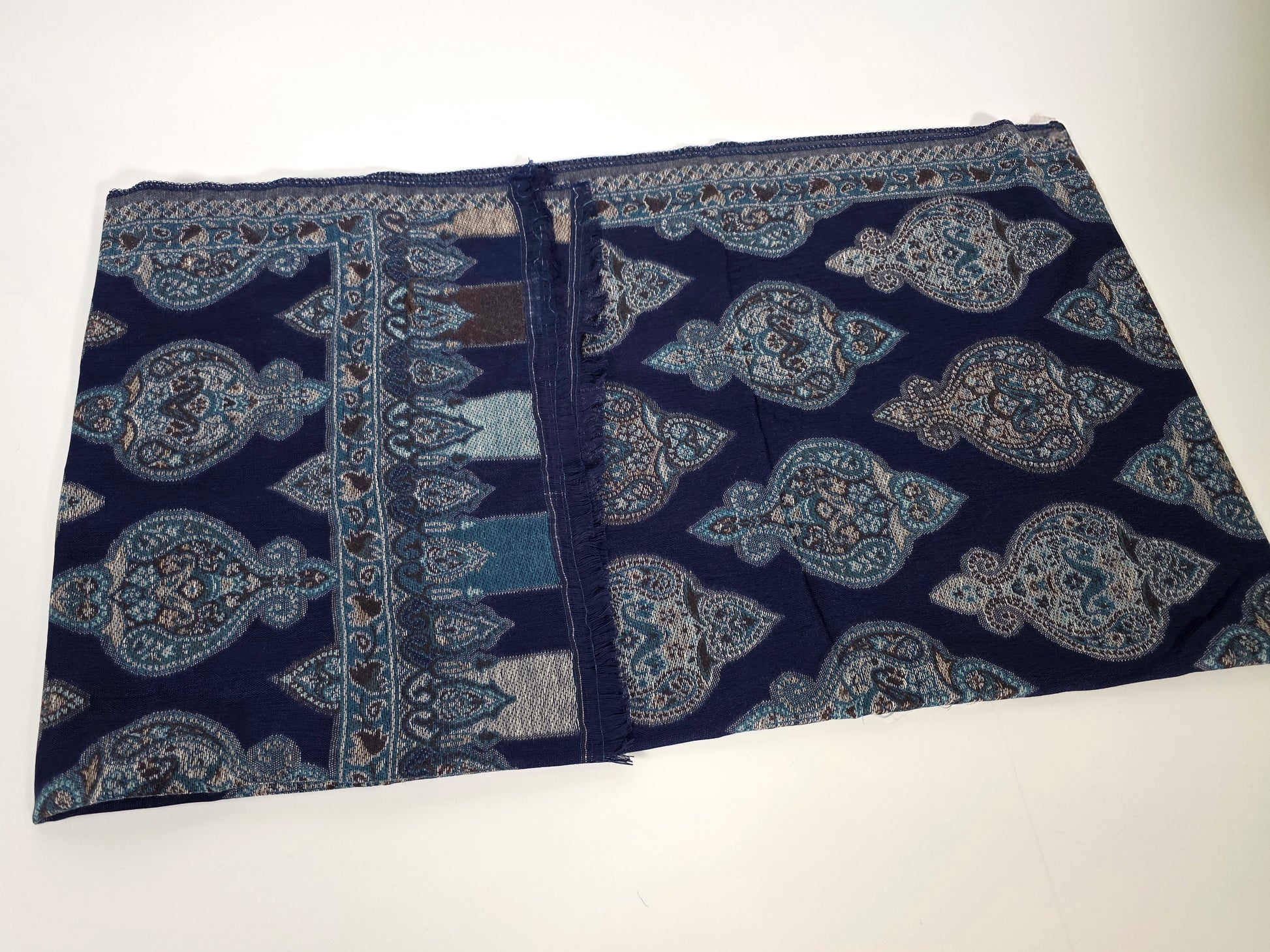 cotton wool shawl with dark blue colour and turkish designs, folded.