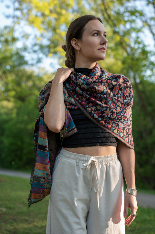 female model wearing a colourful cotton and wool Turkish shawl, the rainbow.