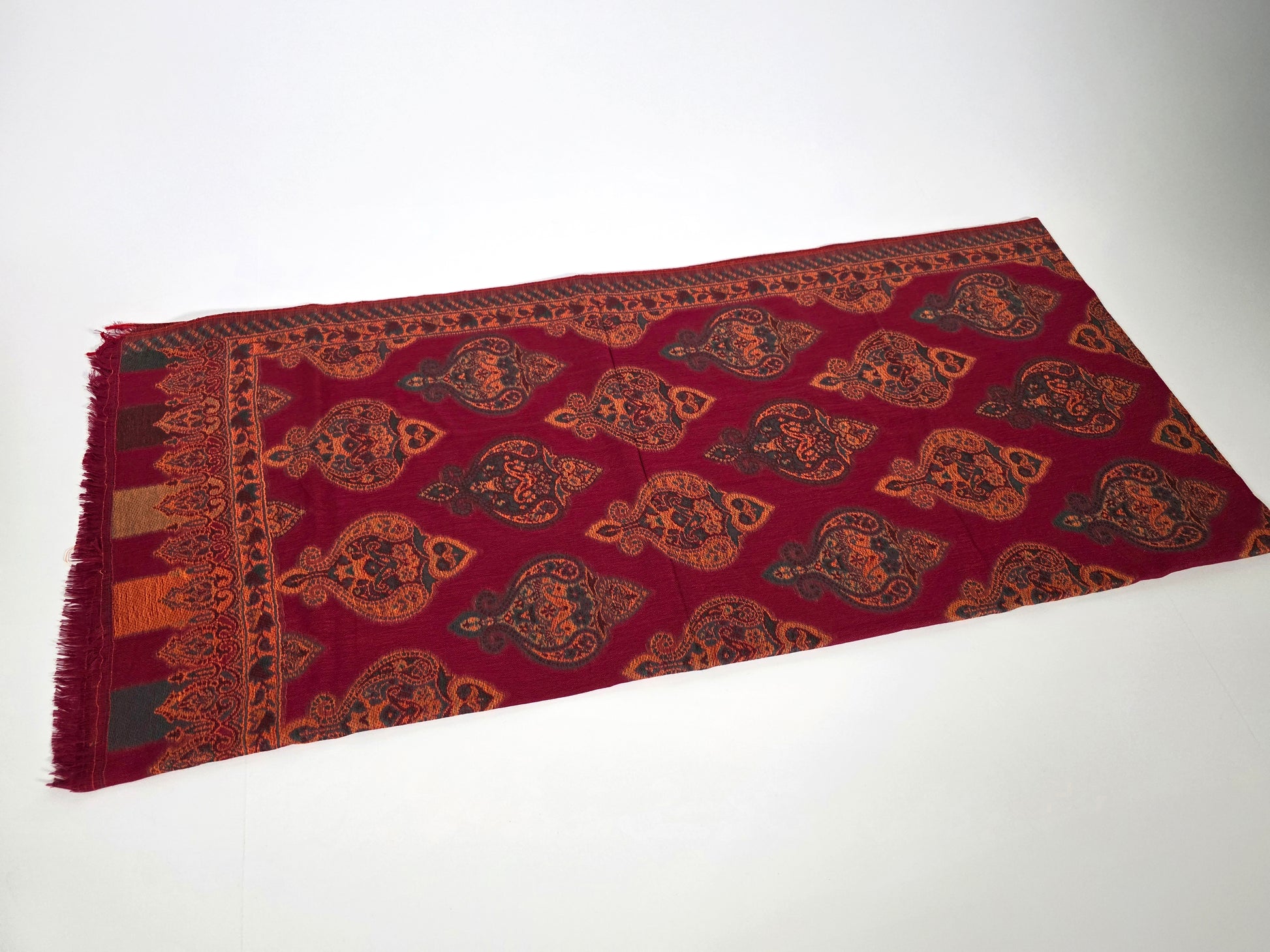 red cotton wool shawl with turkish designs, folded.