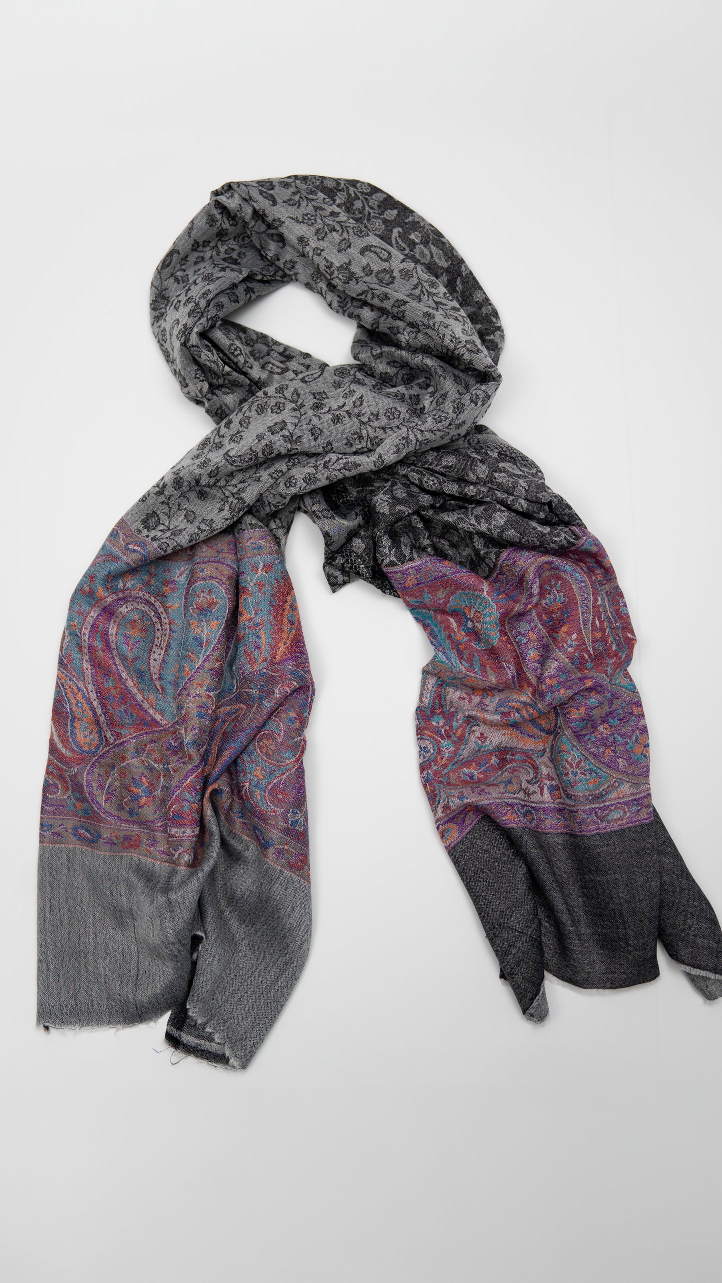 turkish cashmere shawl, black and grey with coloured accents, wrapped.