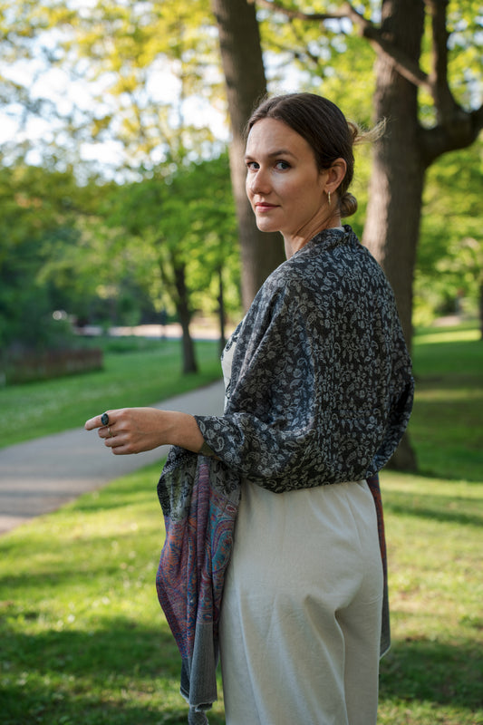 female model wearing black, white, and purple cashmere shawl