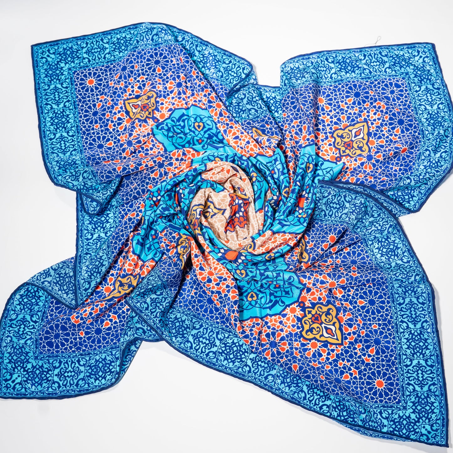vegan silk scarf with light and dark blue, yellow, orange, and white tones, featuring intricate designs. 