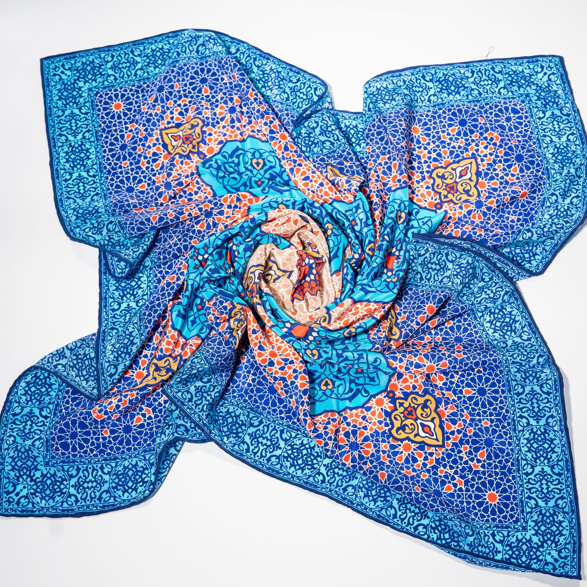 vegan silk scarf with light and dark blue, yellow, orange, and white tones, featuring intricate designs. 