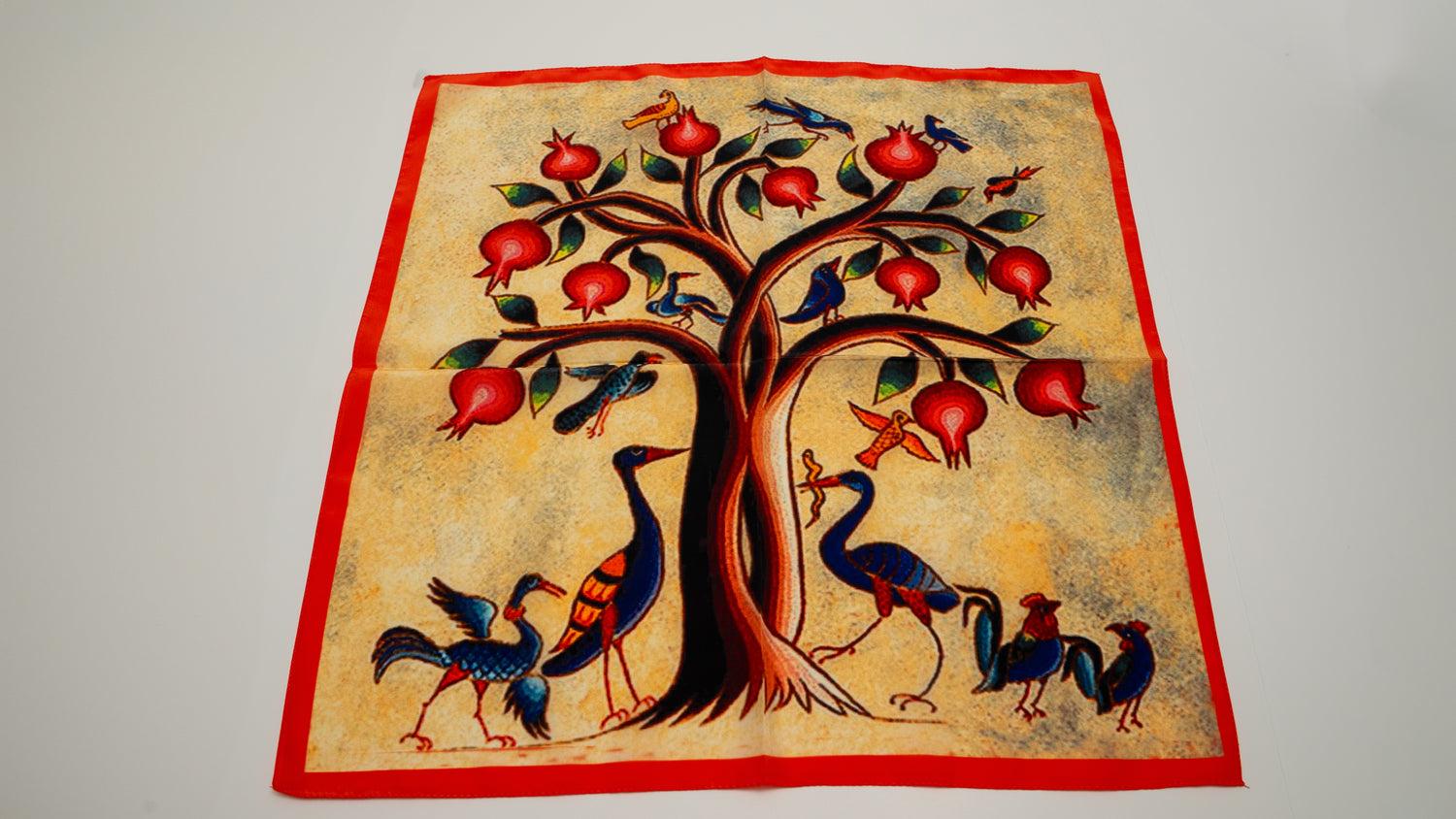 a square vegan silk bandana featuring a pomegranate tree with birds