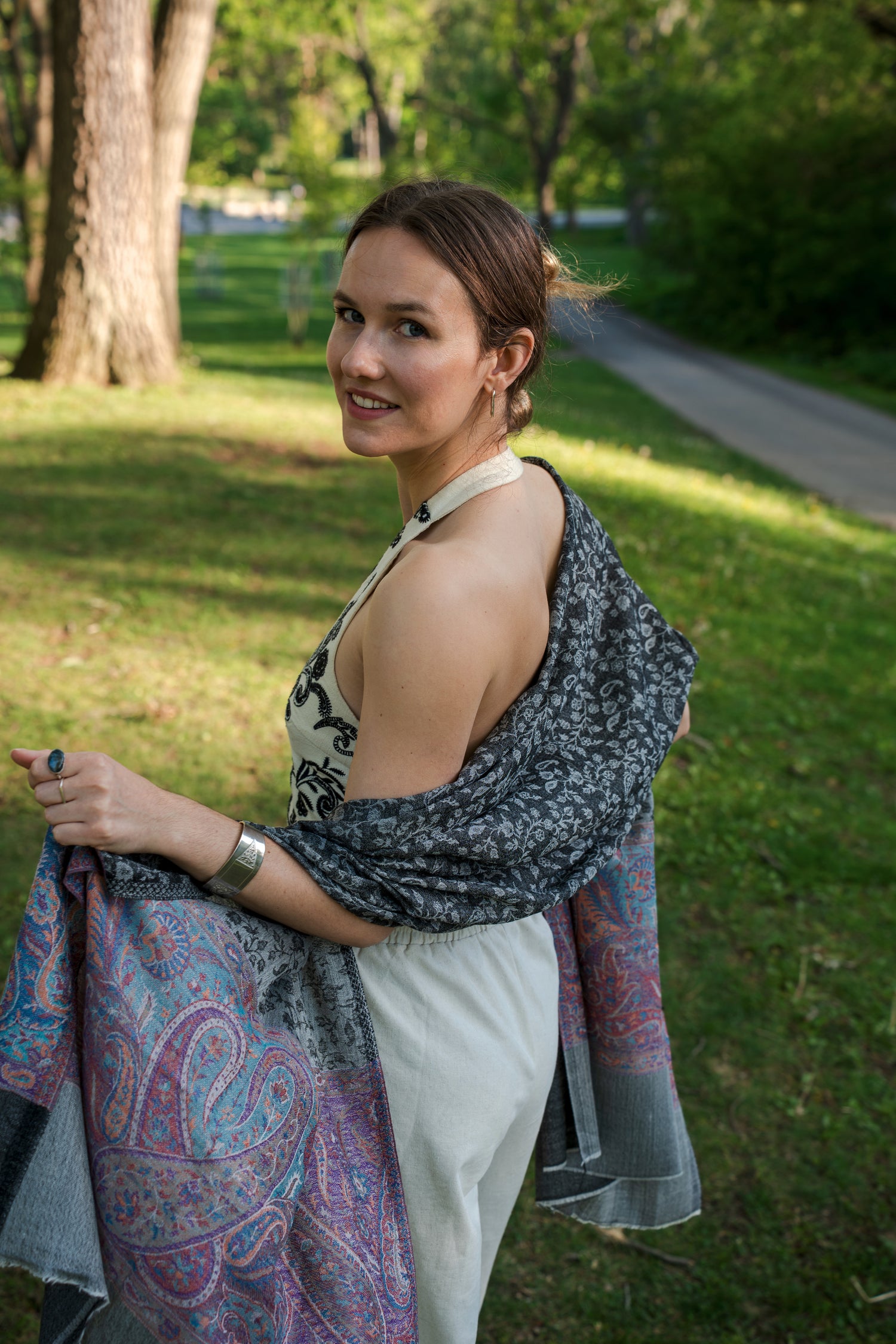 female model wearing black, white, and purple cashmere shawl